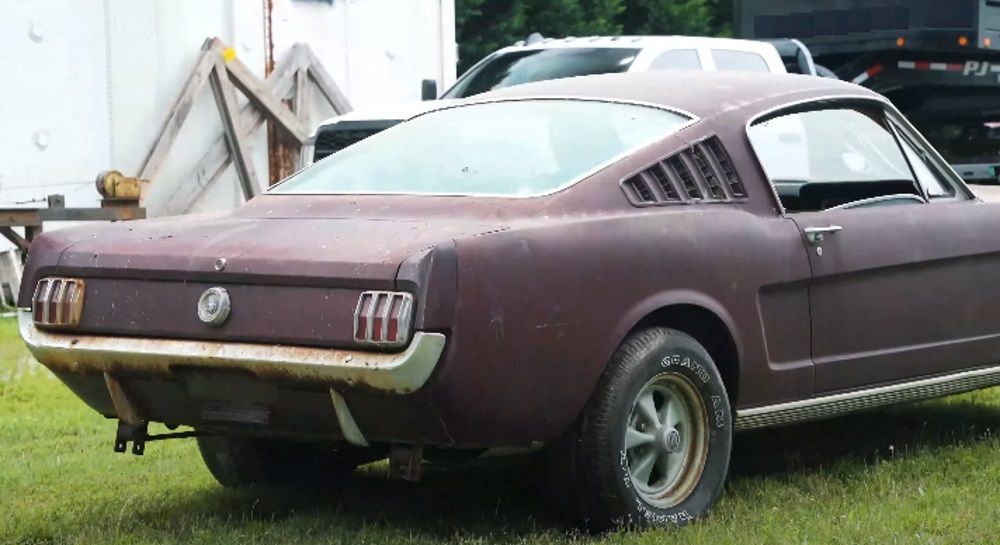 Rear/Side view of a 1965 A-Code Ford Mustang Fastback, rusty red