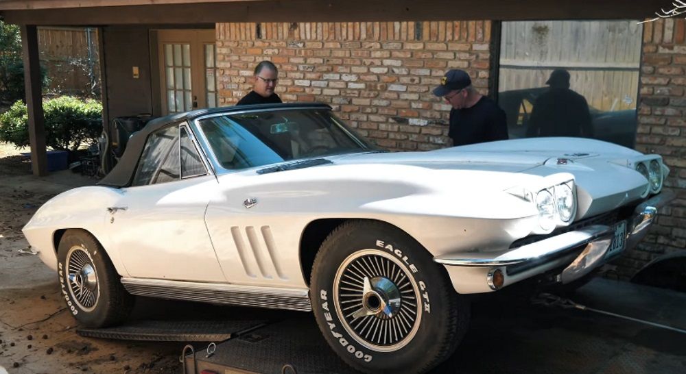 Loading a white 1966 Chevy Corvette Convertible onto a trailer, front quarter view