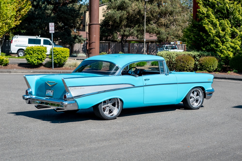 blue vintage car on road during daytime