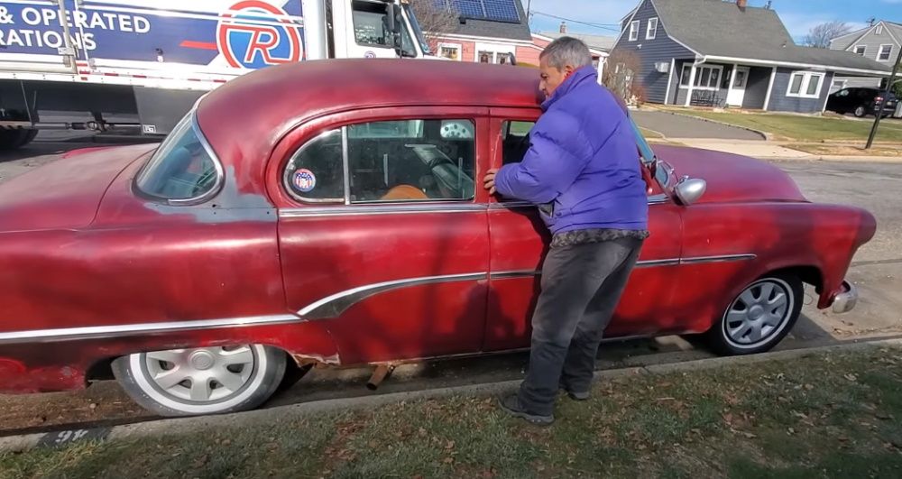 Seller Emilio next to his 1954 Dodge Sedan